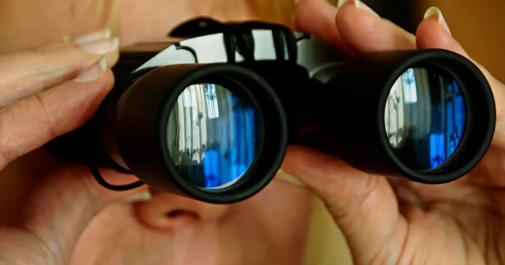 They are using a telescope to observe the other party.