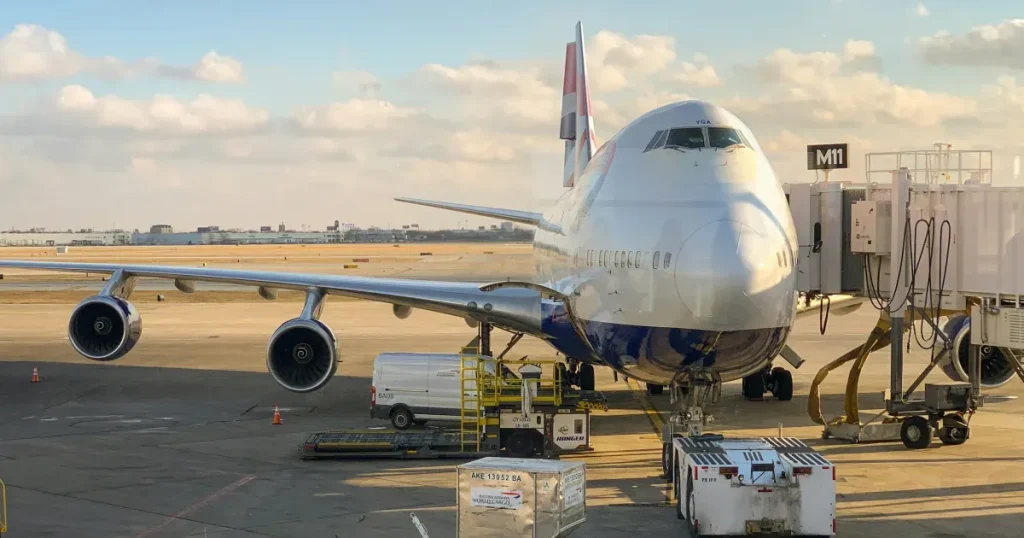 A large airplane is undergoing maintenance after landing.